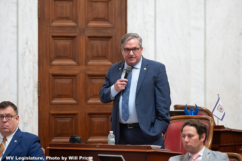 State legislator speaking at podium during legislative session on data center regulation